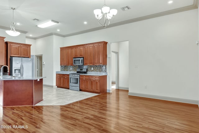 315 Begnaud Dr, Lafayette, LA 70501 - kitchen featuring decorative light fixtures, ornamental molding, tasteful backsplash, and stainless steel appliances