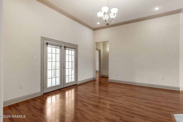 315 Begnaud Dr, Lafayette, LA 70501 - spare room with hardwood / wood-style flooring, a notable chandelier, ornamental molding, and french doors