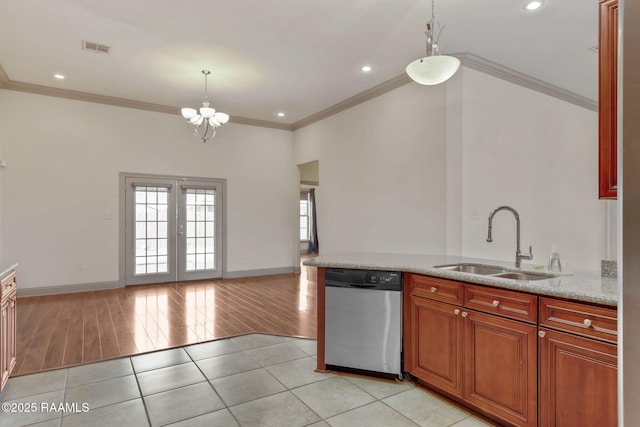 315 Begnaud Dr, Lafayette, LA 70501 - kitchen with light stone countertops, dishwasher, hanging light fixtures, light tile patterned floors, and sink