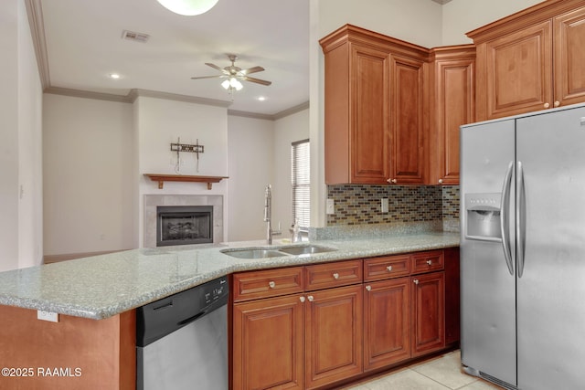 315 Begnaud Dr, Lafayette, LA 70501 - kitchen featuring kitchen peninsula, appliances with stainless steel finishes, sink, backsplash, and light tile patterned flooring