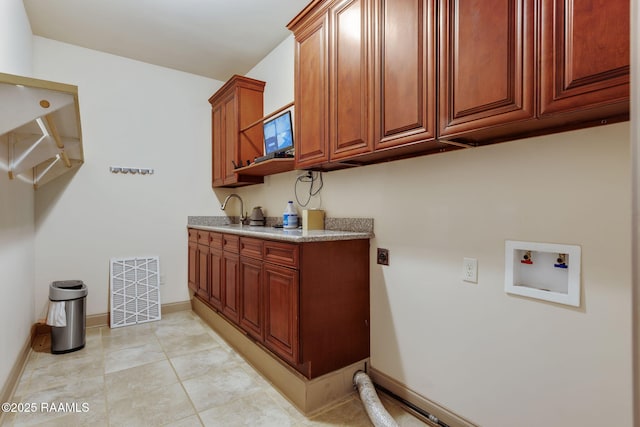 315 Begnaud Dr, Lafayette, LA 70501 - laundry area featuring cabinets, electric dryer hookup, sink, hookup for a washing machine, and light tile patterned floors