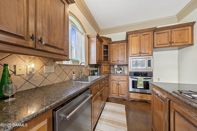 kitchen featuring backsplash, stainless steel appliances, dark stone countertops, and sink