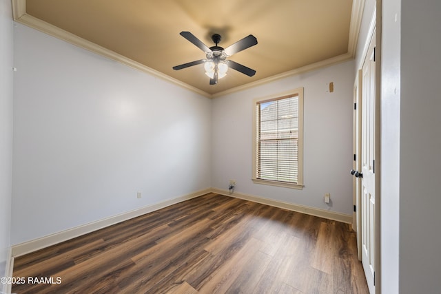 spare room featuring dark hardwood / wood-style floors, ceiling fan, and crown molding