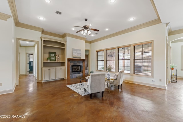 living room featuring ceiling fan, ornamental molding, built in shelves, and a tiled fireplace