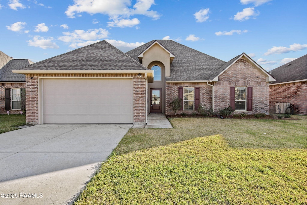 view of front of property featuring a garage and a front lawn