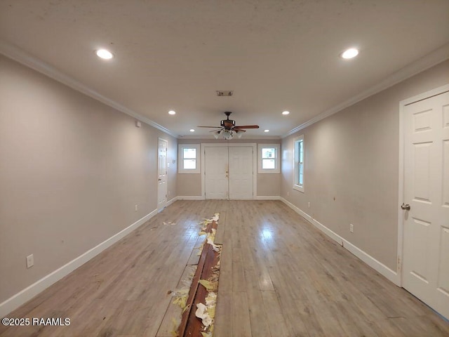 empty room with a ceiling fan, baseboards, recessed lighting, crown molding, and light wood-type flooring