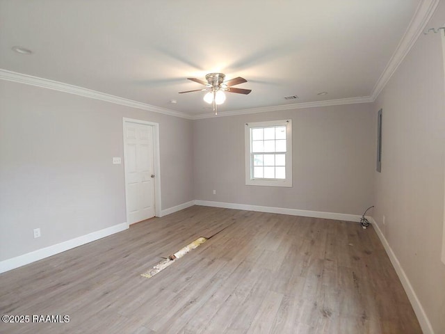 spare room featuring ceiling fan, baseboards, light wood-style floors, and ornamental molding