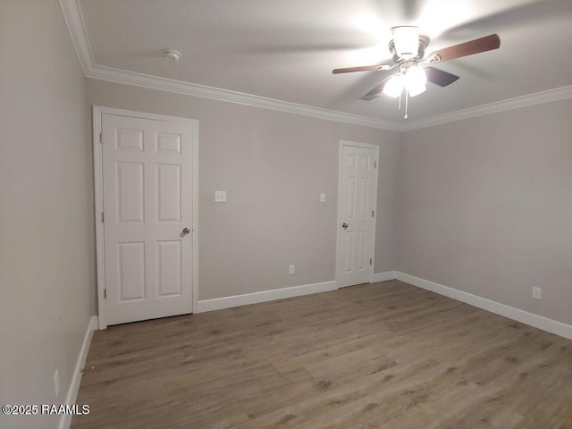 spare room with ceiling fan, crown molding, and light hardwood / wood-style flooring