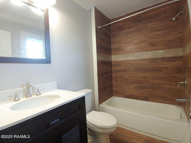 full bathroom with vanity, toilet, tiled shower / bath, and crown molding