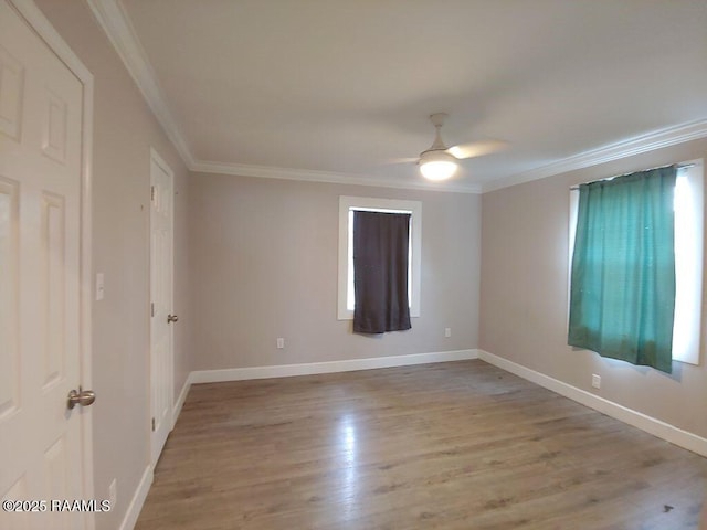 spare room featuring ceiling fan, crown molding, and light hardwood / wood-style flooring