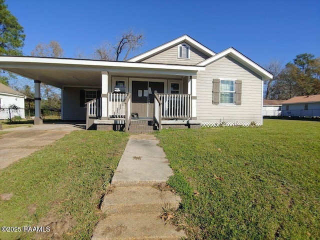 bungalow featuring an attached carport, a porch, a front lawn, and fence