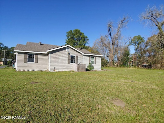 view of side of home with a lawn