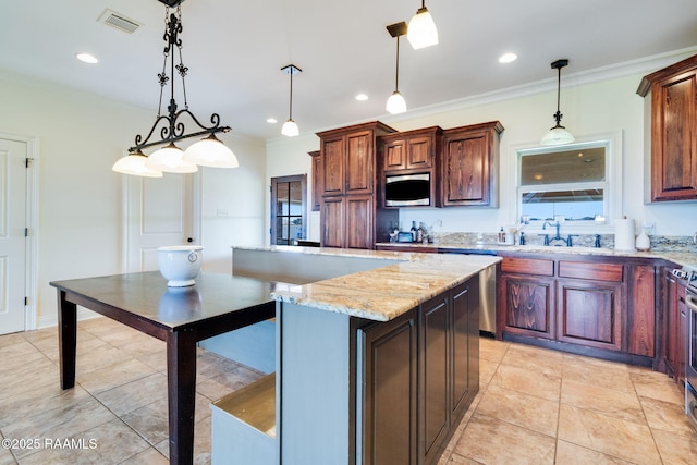 kitchen featuring pendant lighting, sink, ornamental molding, a kitchen island, and light stone counters