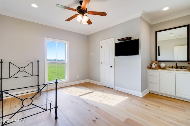 unfurnished bedroom featuring light hardwood / wood-style flooring, crown molding, and sink