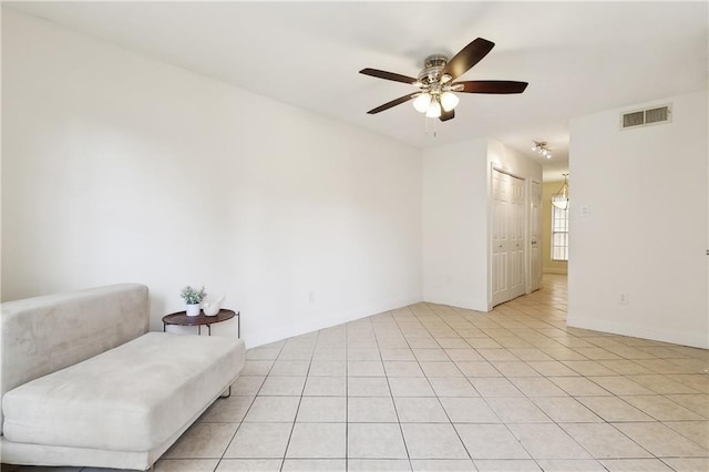 sitting room featuring visible vents, ceiling fan, and light tile patterned floors