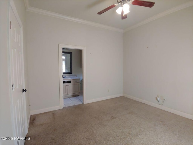 carpeted spare room with ceiling fan and crown molding