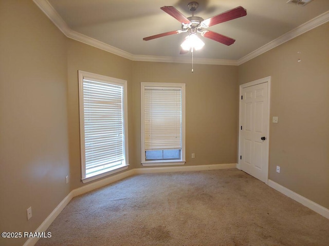 spare room with light carpet, crown molding, and ceiling fan