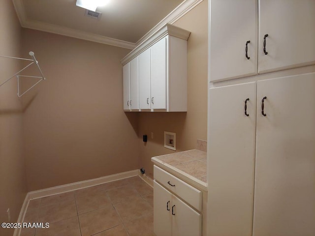 washroom featuring cabinets, washer hookup, ornamental molding, and light tile patterned flooring