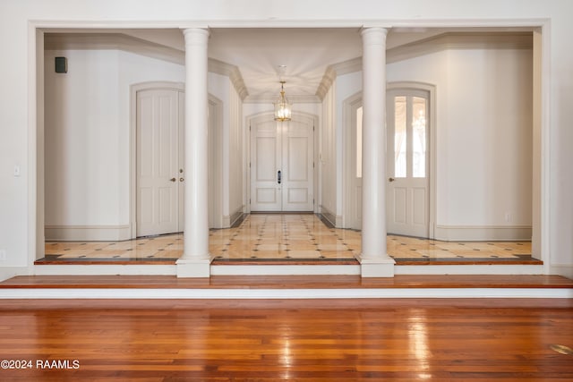 entryway with ornate columns and light wood-type flooring