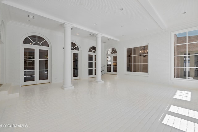 interior space with decorative columns, light hardwood / wood-style flooring, and french doors