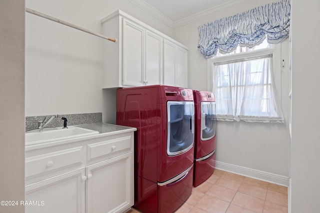 washroom featuring separate washer and dryer, sink, cabinets, ornamental molding, and light tile patterned floors