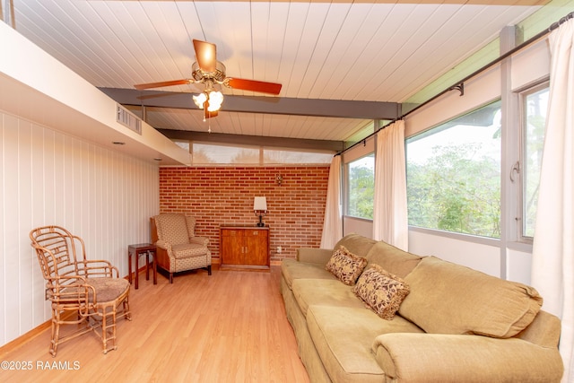 sunroom with ceiling fan, beamed ceiling, and wooden ceiling