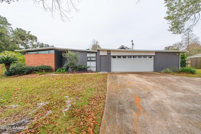 ranch-style house with a garage and a front lawn