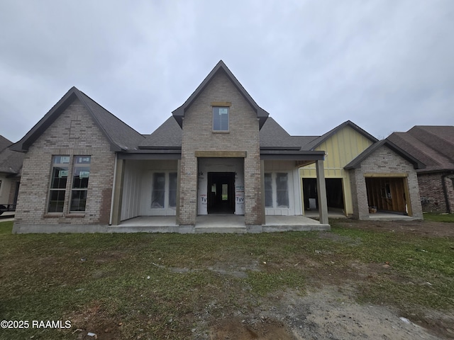 back of house with a lawn and a patio area