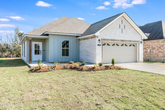 view of front of property featuring a garage and a front lawn