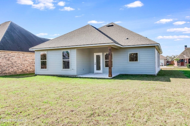 rear view of property with a lawn and a patio