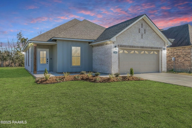 view of front of property with a lawn and a garage