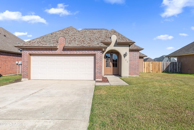 view of front of home with a garage and a front lawn