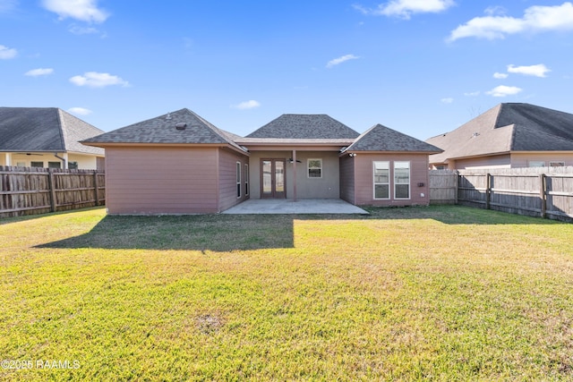 back of property with a yard, french doors, and a patio