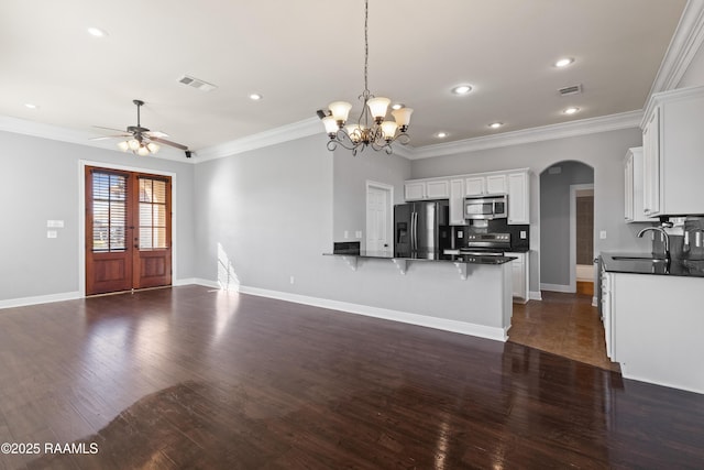 kitchen featuring white cabinetry, sink, hanging light fixtures, and appliances with stainless steel finishes