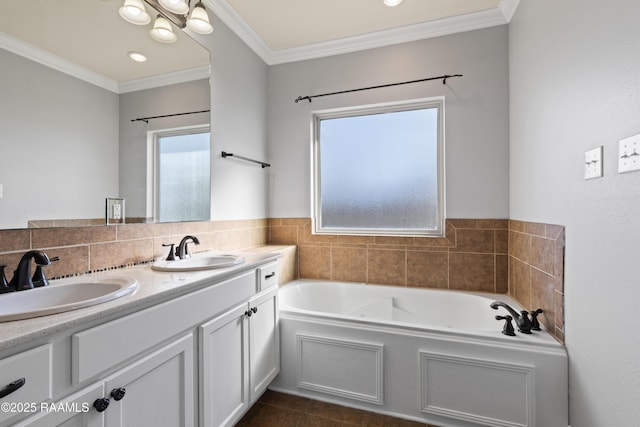 bathroom with tile patterned floors, a washtub, vanity, and ornamental molding