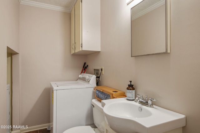 bathroom with sink, toilet, washer / dryer, and crown molding