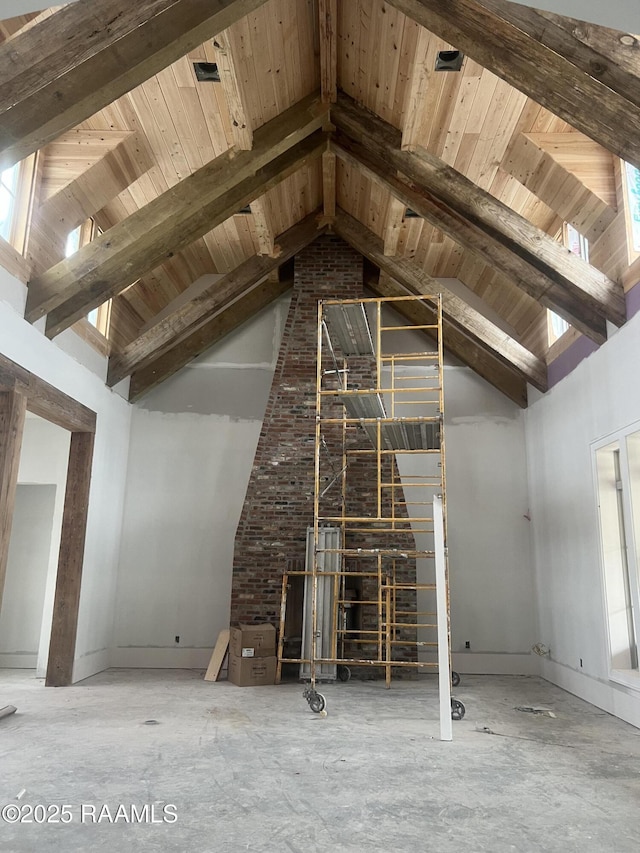 unfurnished living room with beamed ceiling, wood ceiling, and high vaulted ceiling