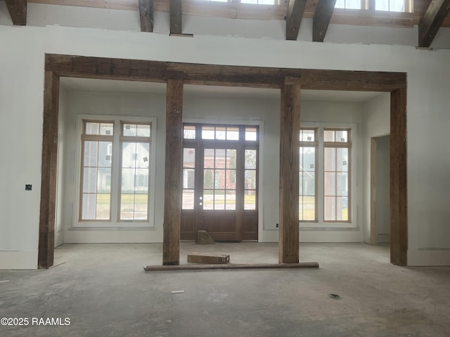 doorway with beamed ceiling