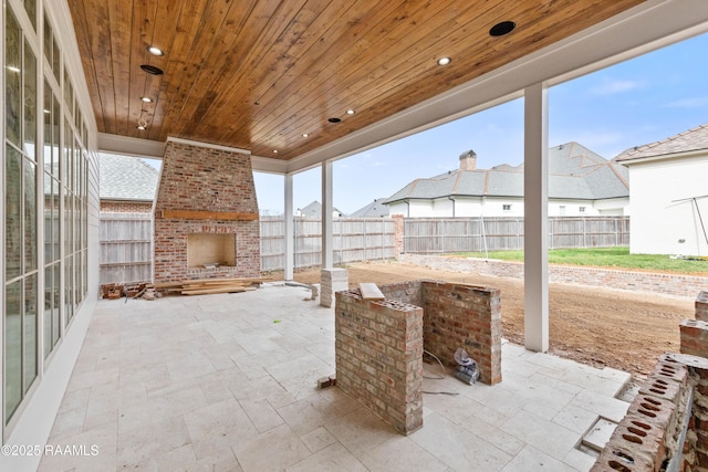 view of patio / terrace featuring an outdoor brick fireplace