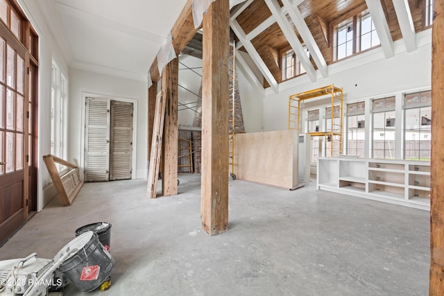 miscellaneous room featuring concrete floors and high vaulted ceiling