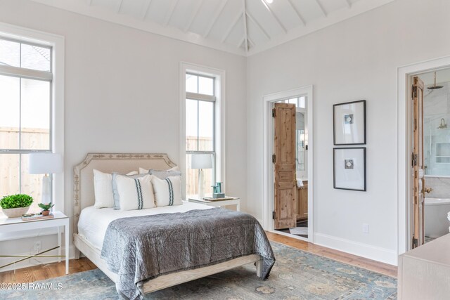 209 Vineyard Row, Lafayette, LA 70508 - bedroom with connected bathroom, wood finished floors, baseboards, and vaulted ceiling