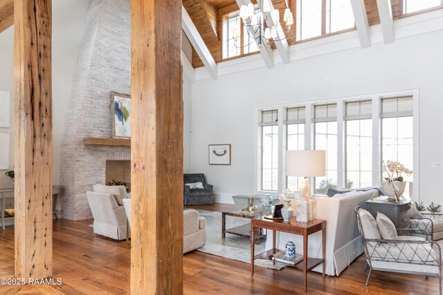 209 Vineyard Row, Lafayette, LA 70508 - living room featuring high vaulted ceiling, beamed ceiling, a chandelier, plenty of natural light, and wood finished floors