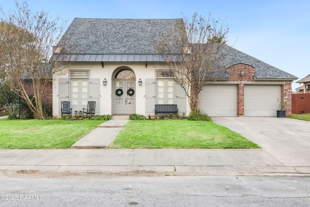 view of front of house with a front yard and a garage