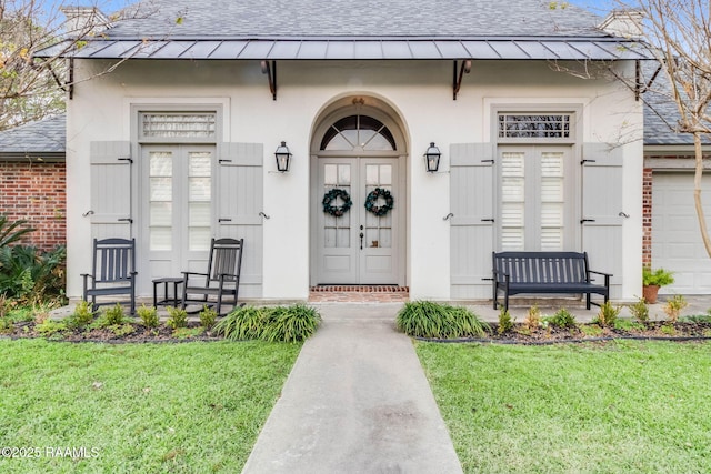 property entrance with a lawn