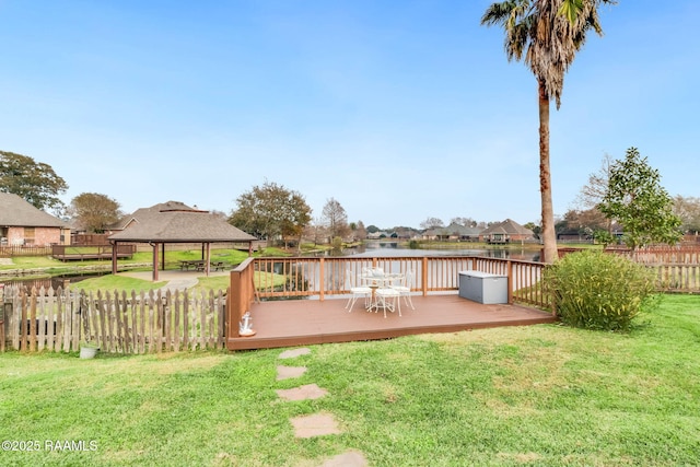 view of yard featuring a deck with water view and a gazebo