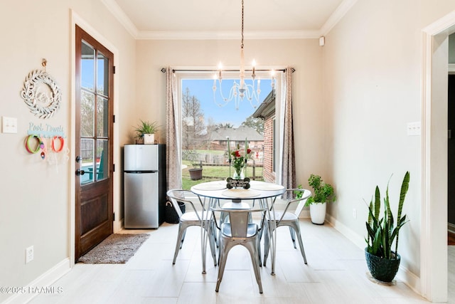 dining room featuring ornamental molding and a notable chandelier