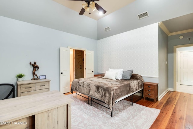 bedroom with lofted ceiling, light hardwood / wood-style flooring, ceiling fan, and crown molding