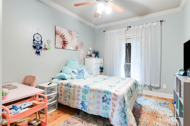 bedroom with hardwood / wood-style floors, ceiling fan, and crown molding