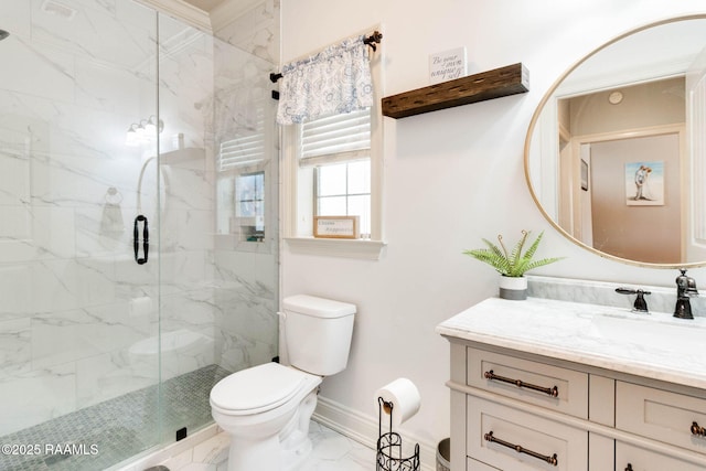 bathroom with a shower with door, vanity, and toilet