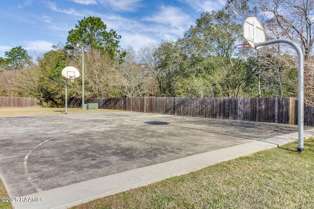 view of basketball court with a yard